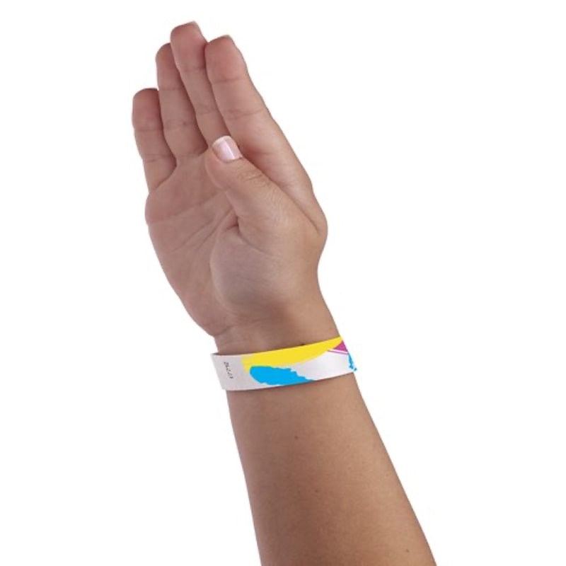 Hand wearing a colourful 90's paintstroke wristband
