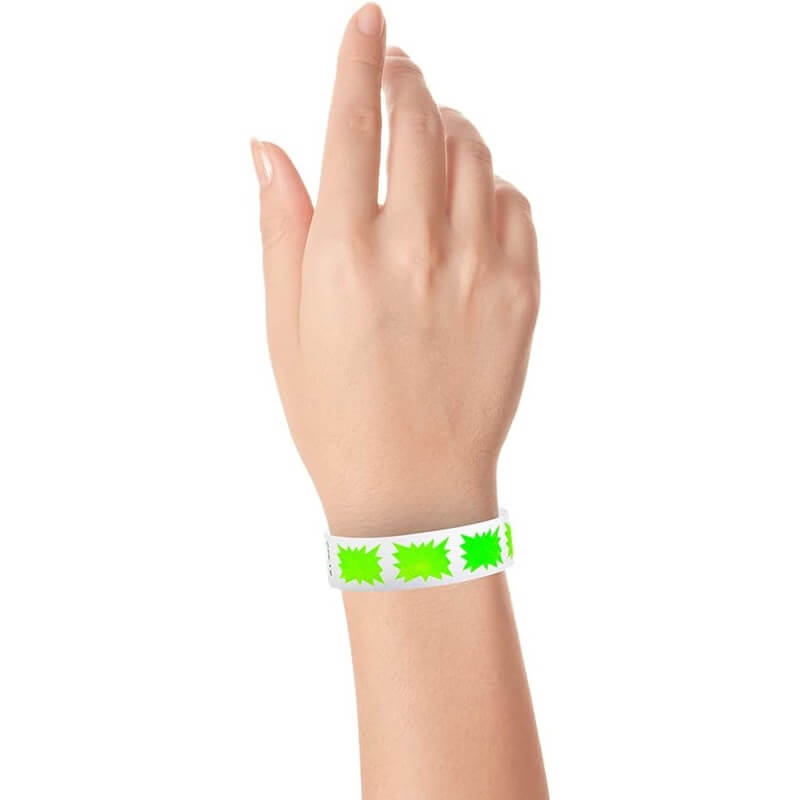 hand wearing a white wristband with neon green burst pattern