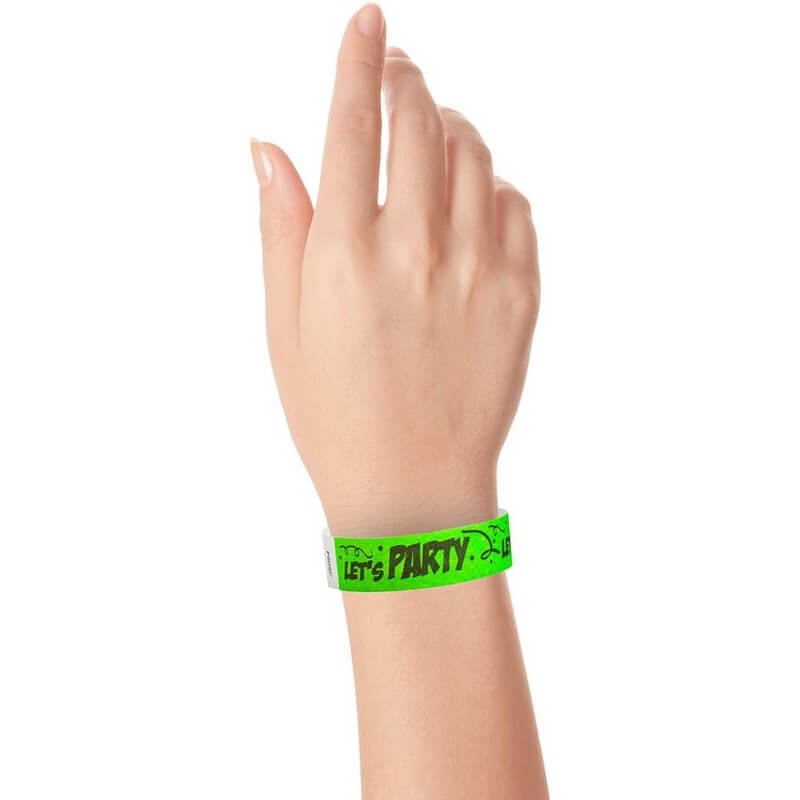 wrist wearing a neon green tyvek wristband with black lettering "Let's Party"