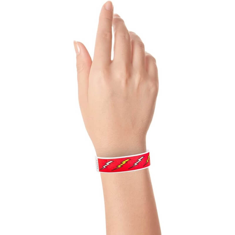 wrist wearing a neon red wristbands with neon yellow and white lightning bolt pattern