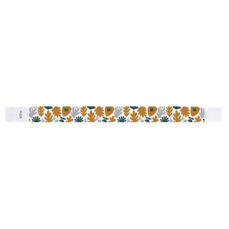 White wristband with colourful leaf pattern in gold, silver and green - flat version shown