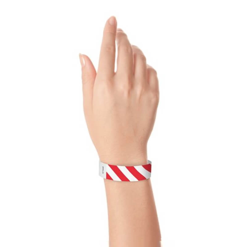 hand wearing white tyvek wristband with neon red diagonal stripes