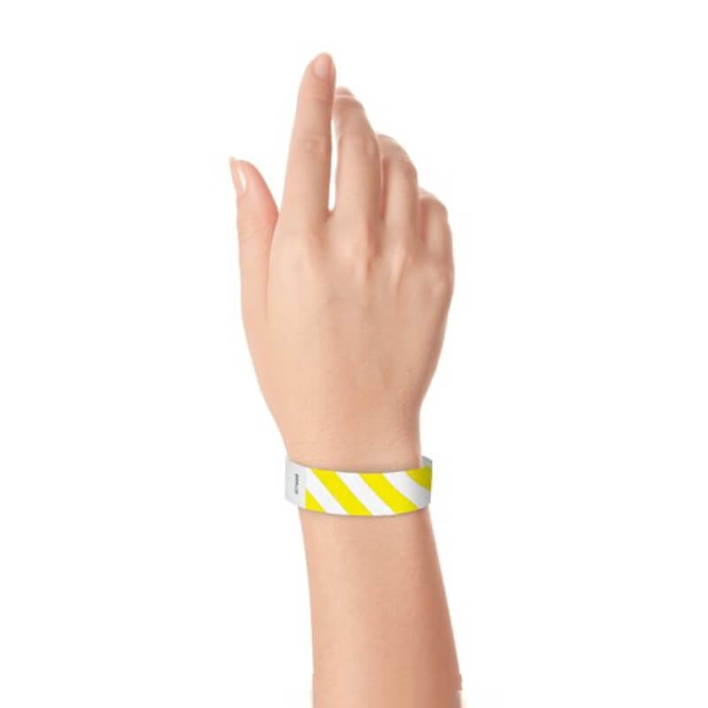 hand wearing white tyvek wristband with neon yellow diagonal stripes