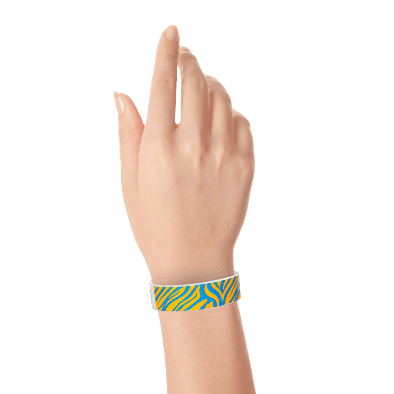 Wrist wearing neon orange tyvek wristband with neon blue zebra pattern