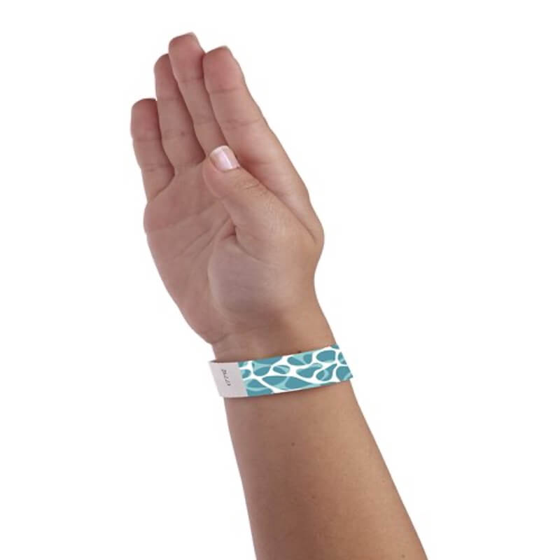 wrist wearing white tyvek wristband with swimming pool pattern in aqua and pantone green