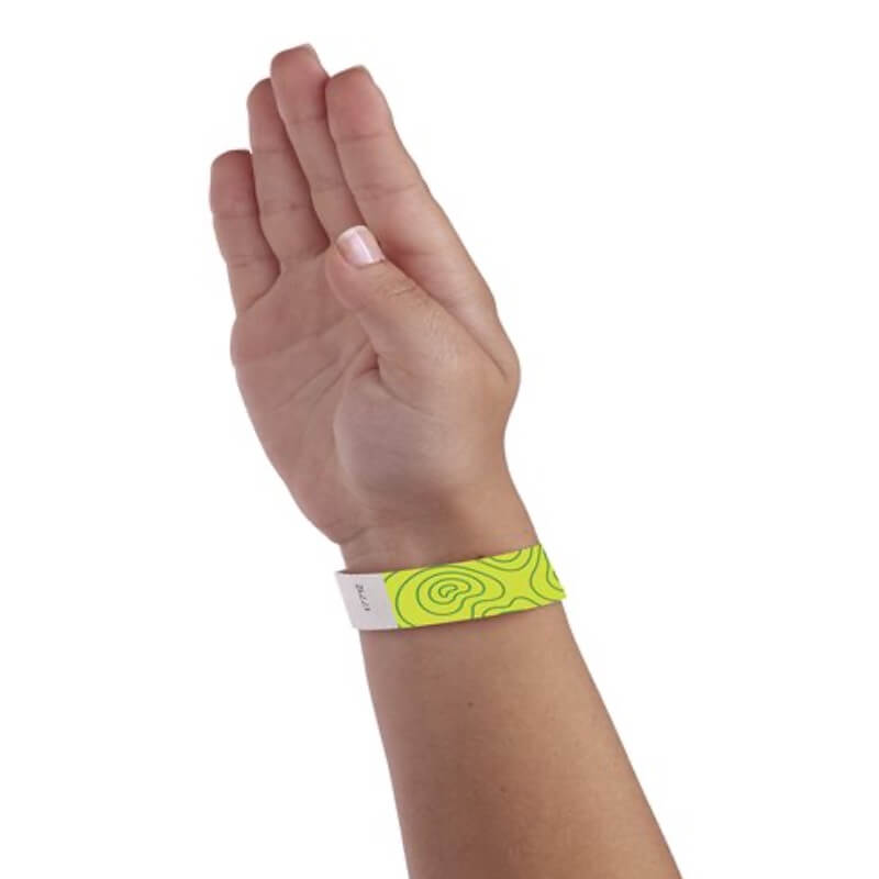hand wearing lime green tyvek wristband with kelly green topographical map design