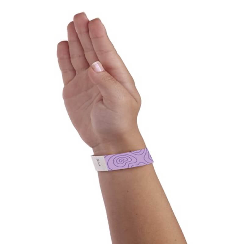 hand wearing berry tyvek wristband with topographical map design in purple