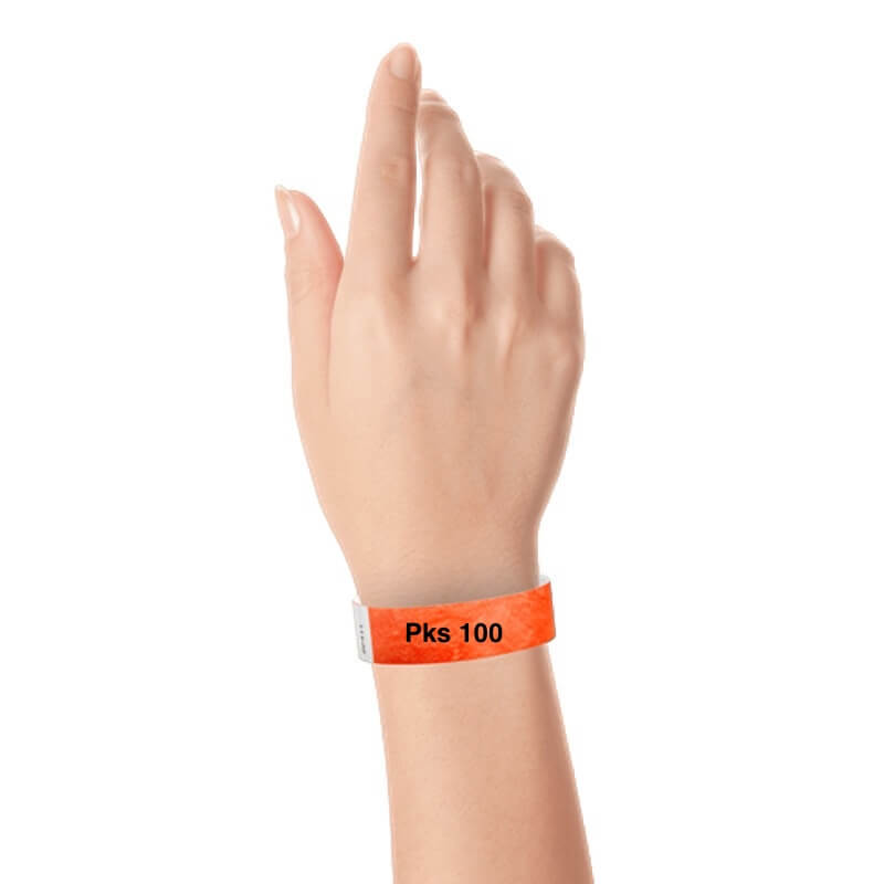 a hand wearing tyvek 3/4" solid wristband coral red pks 100