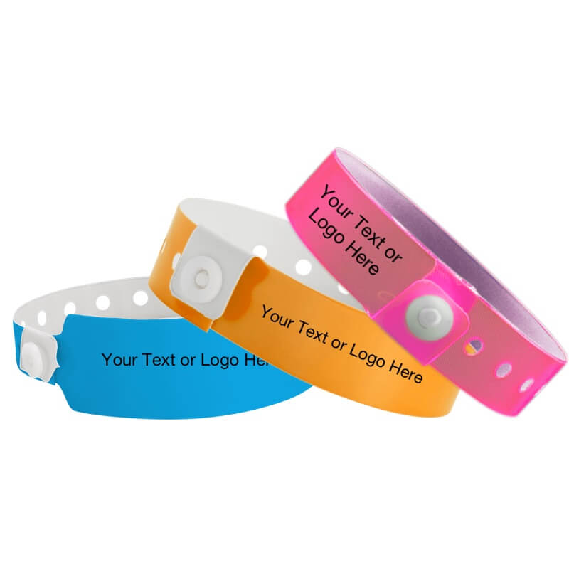 custom vinyl wristbands shown in neon blue wide face, neon orange regular and neon pink edge glow