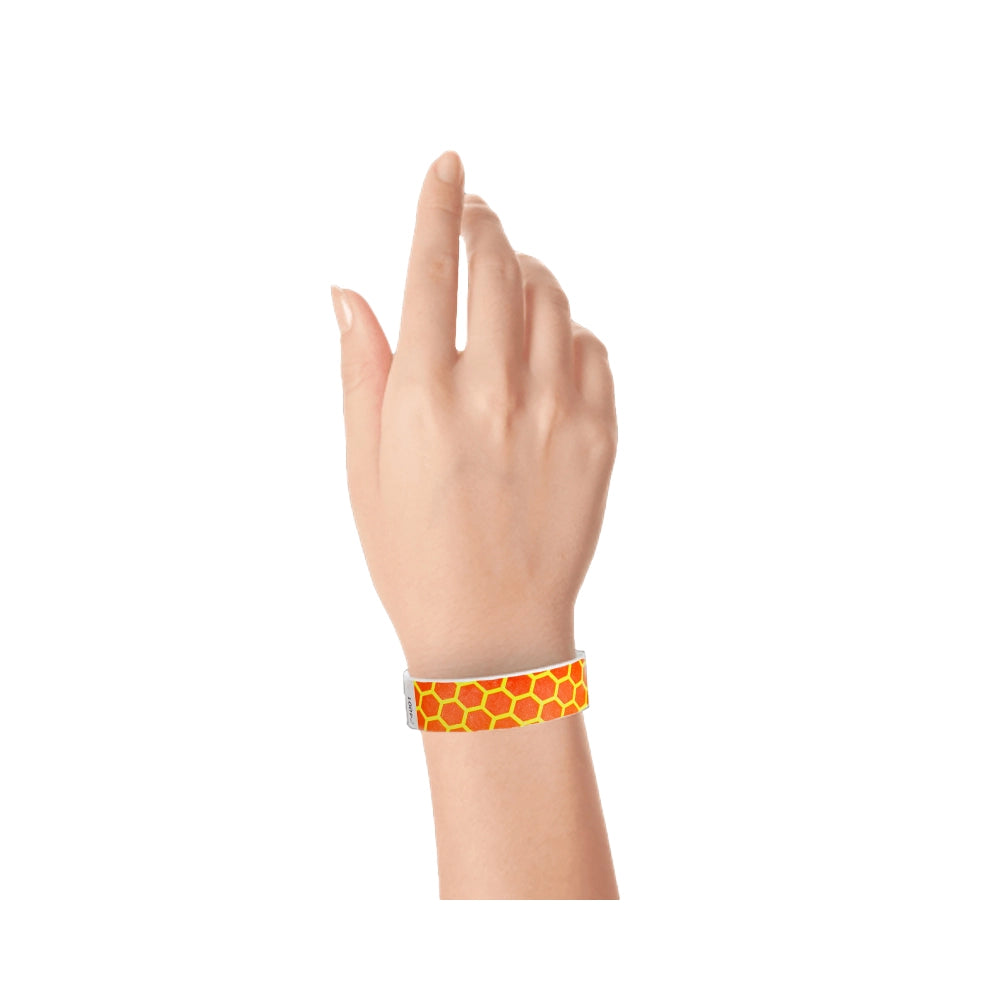 neon orange tyvek wristband with neon yellow honeycomb pattern - shown on hand 