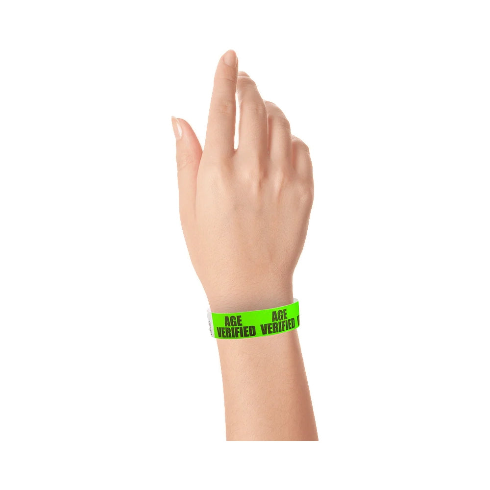 hand wearing a neon green tyvek wristband with age verified text repeated across the band