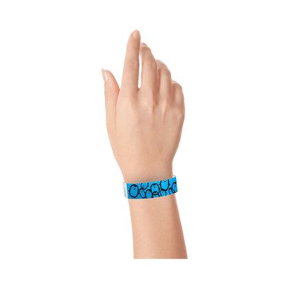 hand wearing a neon blue tyvek wristband with black penguin pattern