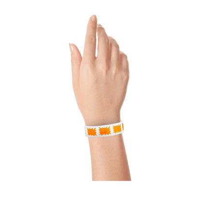 hand wearing a white tyvek wristband with a neon orange burst pattern