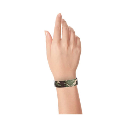 wrist wearing a camouflage patterned tyvek wristband greens and browns