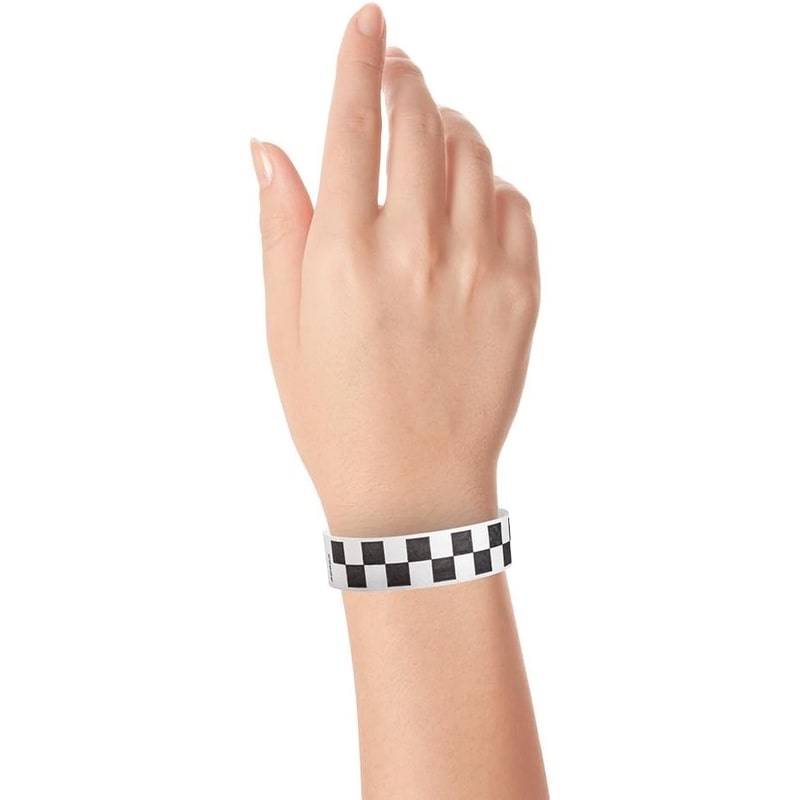 Hand wearing a black and white checkered wristband 