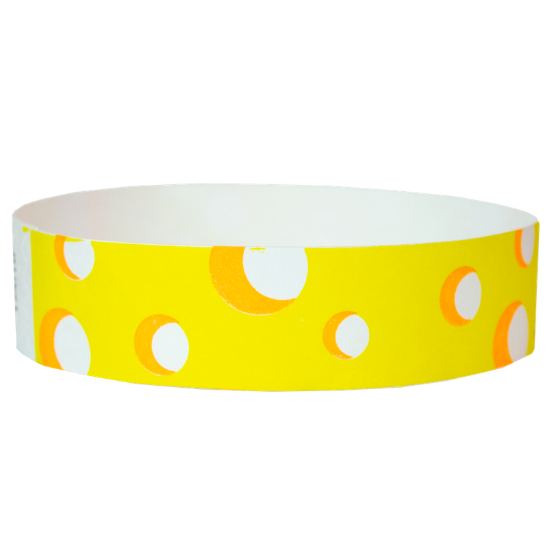 Yellow wristband with white and orange polka dots on a white background