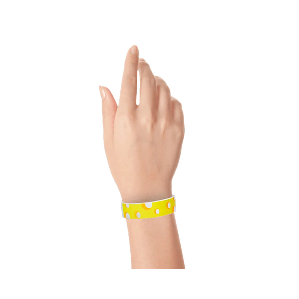 Hand wearing a cheese designed tyvek wristband