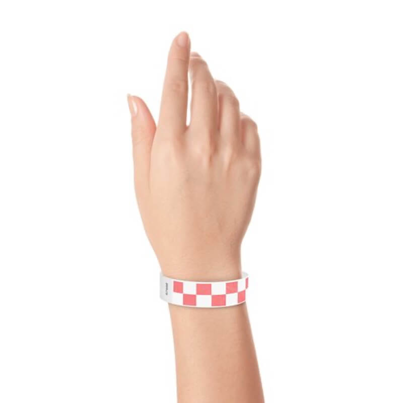 Hand wearing a coral red and white checkered wristband 