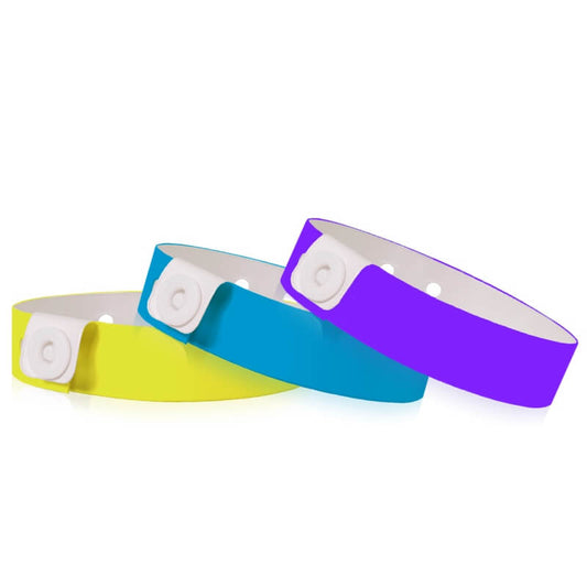 Vinyl slim wristband shown in neon yellow, neon blue and purple