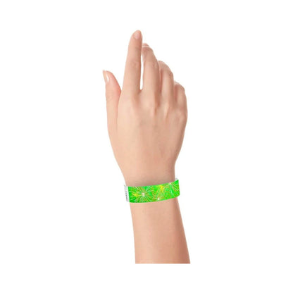 wrist wearing a neon green tyvek wristband with a fireworks pattern in neon yellow, neon orange and white