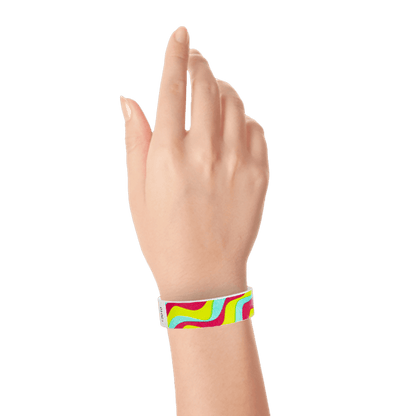 aqua, neon red, neon yellow wavy stripe pattern on a tyvek wristband  shown on a wrist