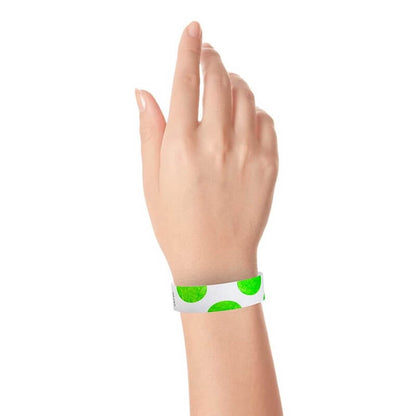 hand wearing a white tyvek wristband with neon green half circles