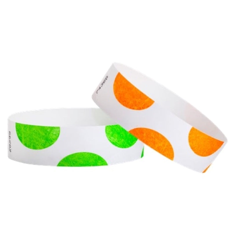 Two white tyvek wristbands with neon orange and neon green half-circle designs