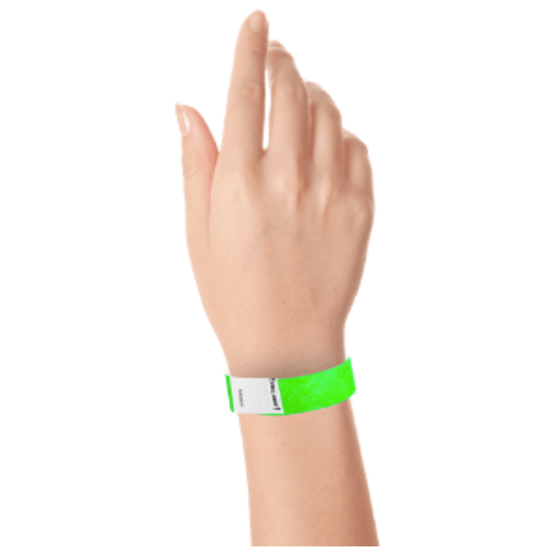 hand wearing a litter free tyvek 3/4" wristband in neon green