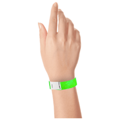 hand wearing a litter free tyvek 3/4" wristband in neon green