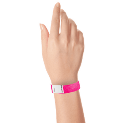 hand wearing a litter free tyvek 3/4" wristband in neon pink
