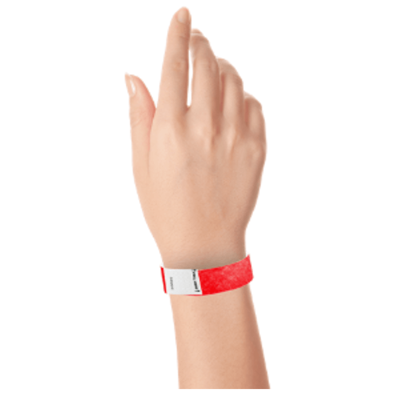hand wearing a litter free tyvek 3/4" wristband in neon red