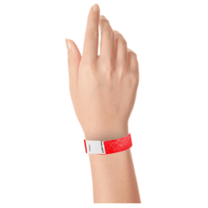 hand wearing a litter free tyvek 3/4" wristband in neon red