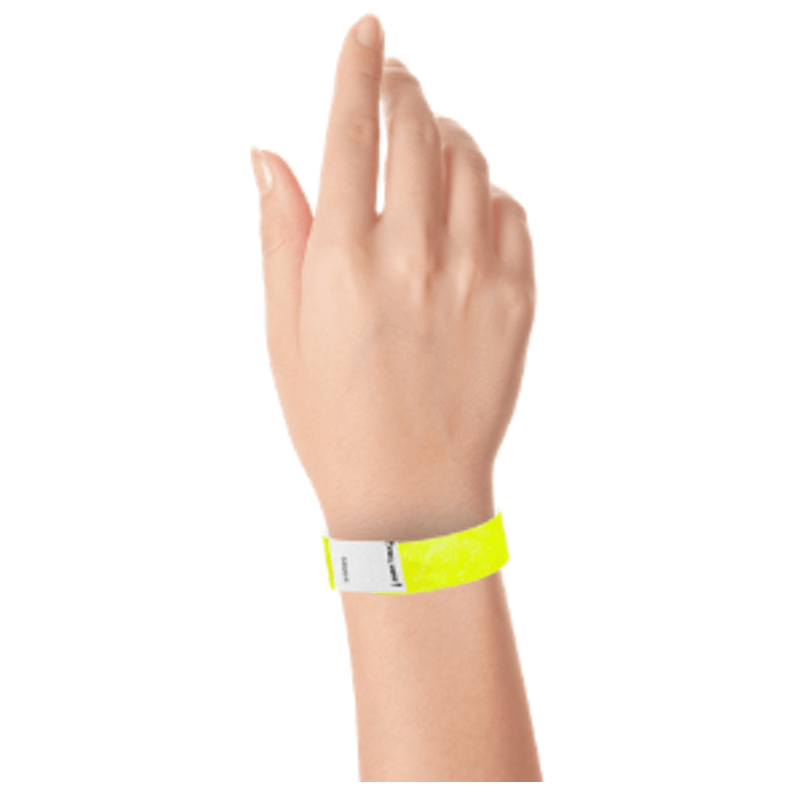 hand wearing a litter free tyvek 3/4" wristband in neon yellow