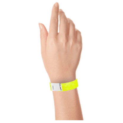 hand wearing a litter free tyvek 3/4" wristband in neon yellow
