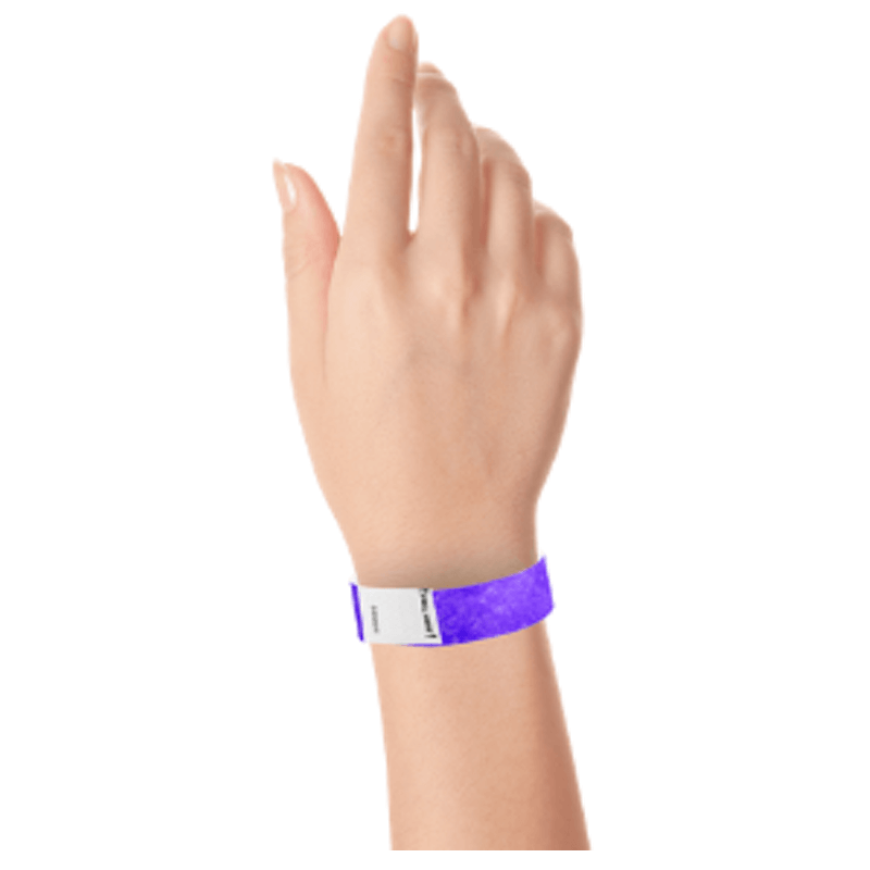 hand wearing a litter free tyvek 3/4" wristband in purple