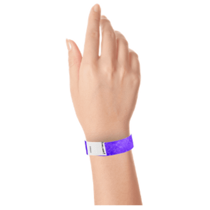 hand wearing a litter free tyvek 3/4" wristband in purple