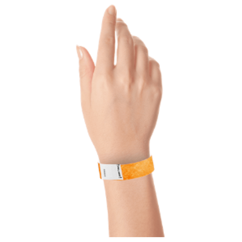 hand wearing a litter free tyvek 3/4" wristband in neon orange