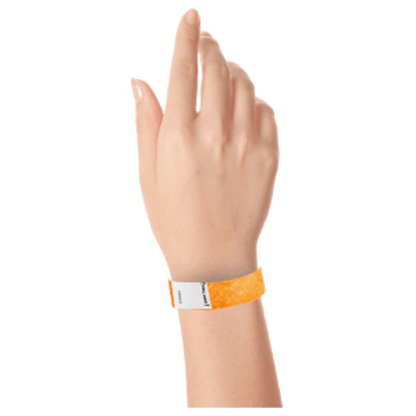 hand wearing a litter free tyvek 3/4" wristband in neon orange