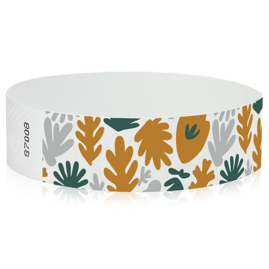 White wristband with colourful leaf pattern in gold, silver and green - round version shown 