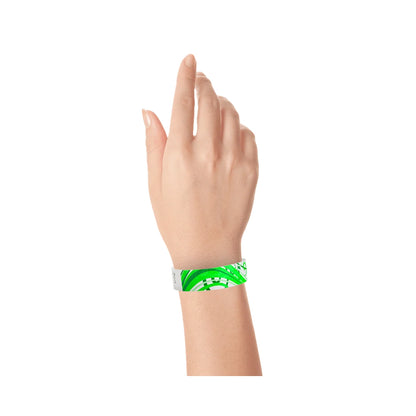 wrist wearing a white tyvek wristband with neon green and kelly green nature pattern