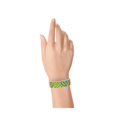 Wrist wearing neon orange tyvek wristband with neon blue zebra pattern 
