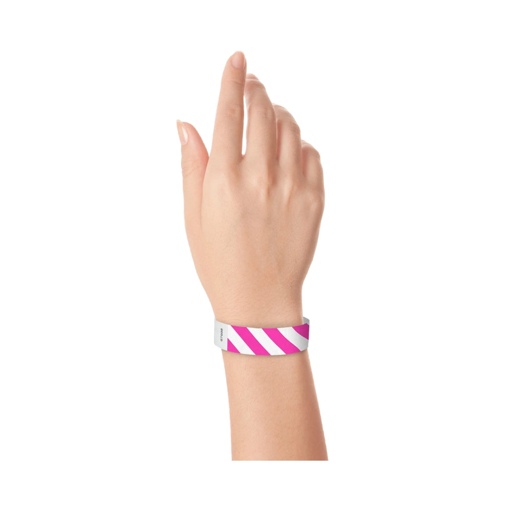 hand wearing white tyvek wristband with pink diagonal stripes