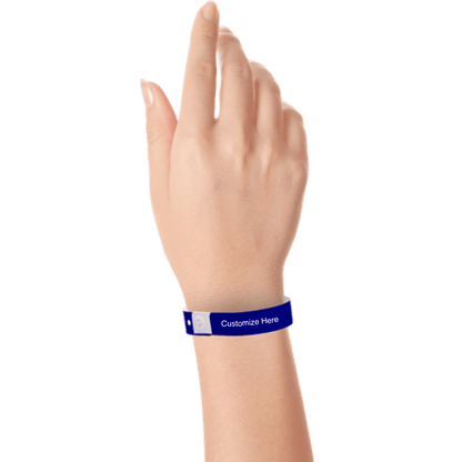 Hand wearing slim plastic wristband with a placeholder to show where you can customize the wristband shown in navy blue