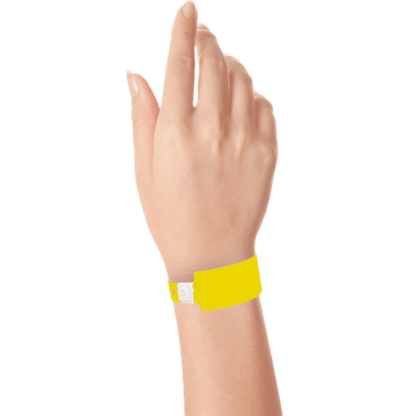 Wide face plastic solid wristband on hand in pantone yellow
