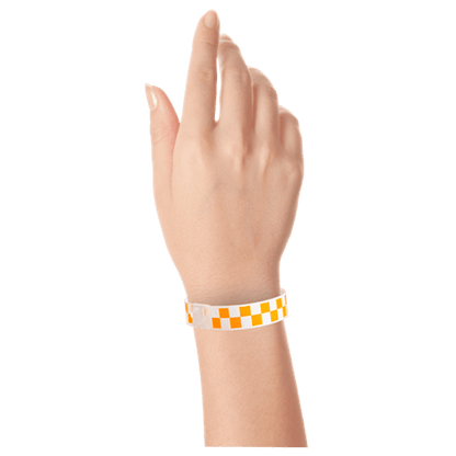 Plastic checkerboard wristband on hand in neon orange