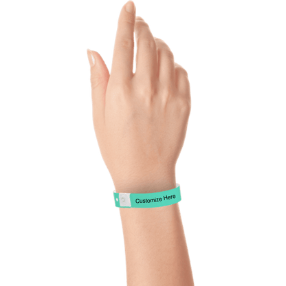 hand wearing plastic regular 3/4" wristband with a placeholder to show where you can customize the wristband in aqua