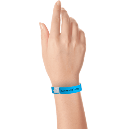 hand wearing plastic regular 3/4" wristband with a placeholder to show where you can customize the wristband in neon blue