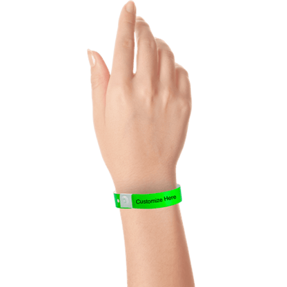 hand wearing plastic regular 3/4" wristband with a placeholder to show where you can customize the wristband in neon green