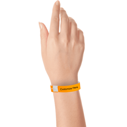hand wearing plastic regular 3/4" wristband with a placeholder to show where you can customize the wristband in neon orange