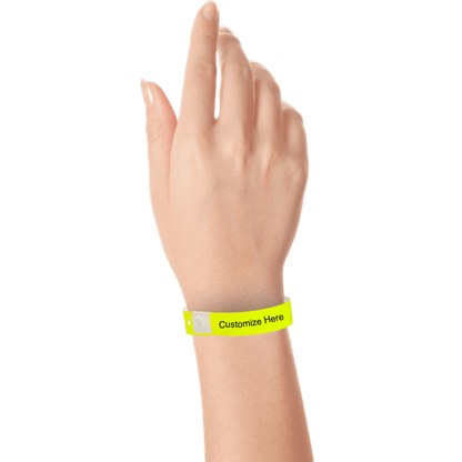 hand wearing plastic regular 3/4" wristband with a placeholder to show where you can customize the wristband in neon yellow